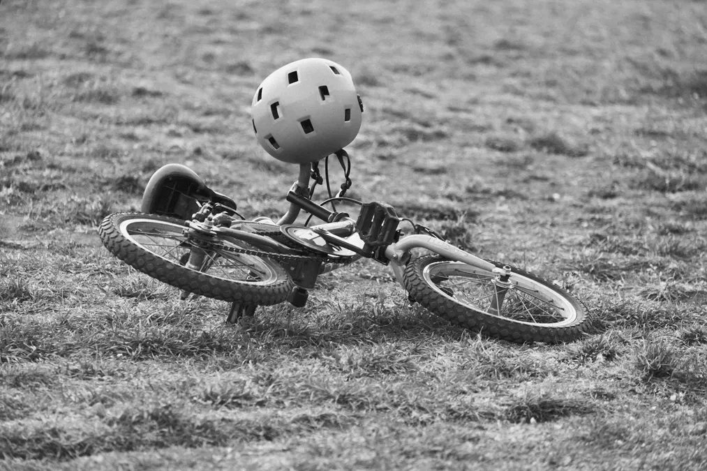 Cyclist wearing safety helmet riding on road - bicycle accident prevention