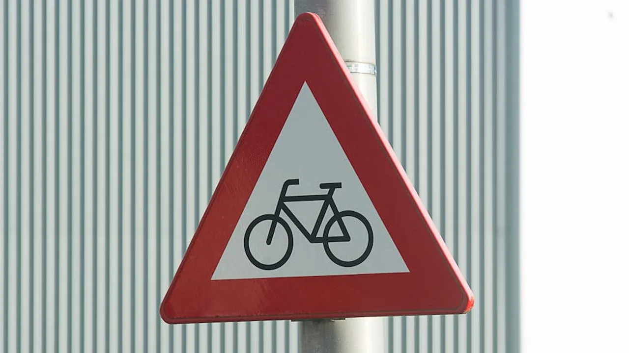 Cyclist riding safely on California road with safety gear
