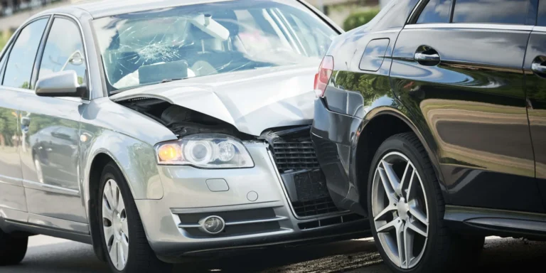 A Deldar Legal attorney speaking with a woman recovering from a rear-end collision injury in a bright California office