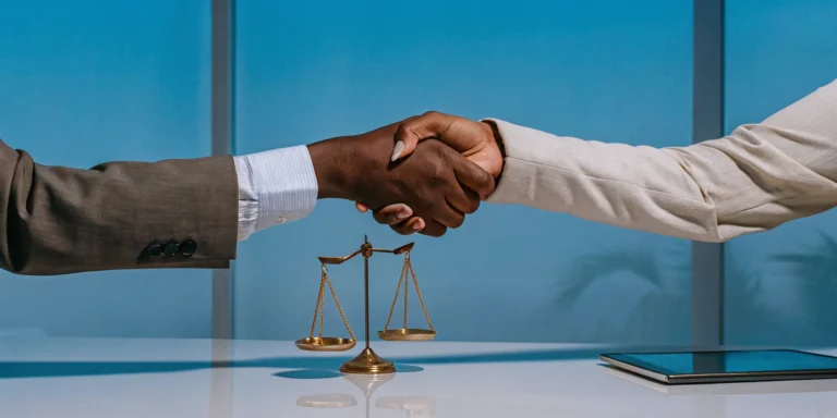 Handshake and scales of justice for a no win, no fee personal injury lawyer in Los Angeles.