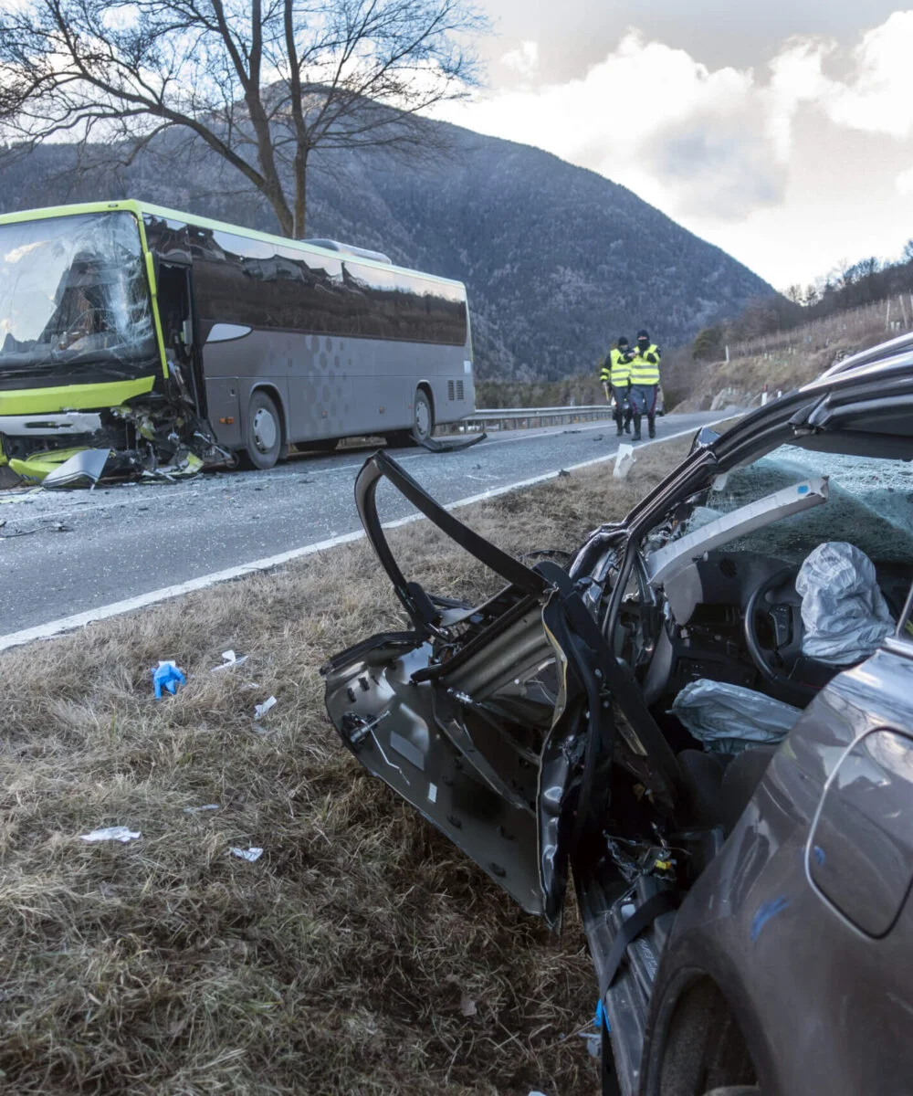 Violent head-on collision between a bus and a car traveling in the opposite direction at the end of the day. A victim due to high speed or drunk driving car crash at sunset or sunrise.