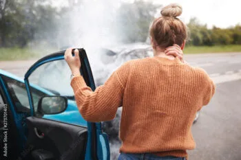 Injured woman holding her neck in pain after a crash and seeking help from a California whiplash injury lawyer.