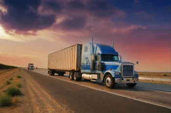 A large semi-truck driving down a California highway, representing one of the many causes of truck accidents discussed in the blog.