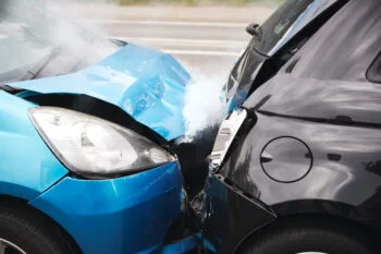 A close-up of two vehicles after a minor fender bender accident, showing light damage to the bumpers from a small collision in California traffic.