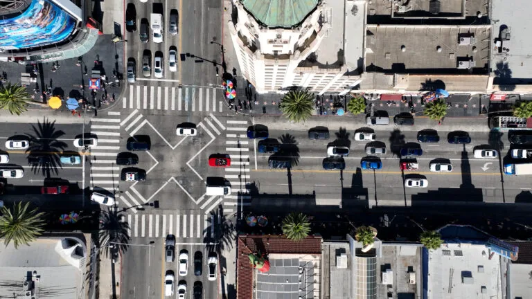 An overhead view of a crowded Hollywood Boulevard crosswalk in Los Angeles, symbolizing when someone might need a pedestrian accident lawyer in California after being hit.