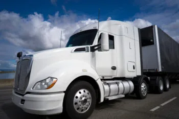 A large semi-truck driving down a busy highway, representing the question many people ask, what does a truck accident attorney do after a serious crash.