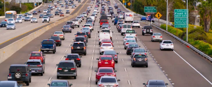 Cars travel on a multilane freeway in San Diego, representing how lane changing rules impact accident claims across California.