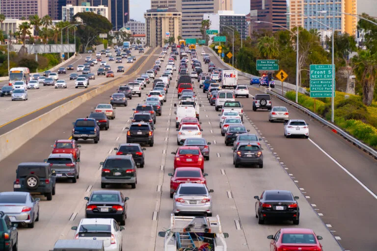 Cars travel on a multilane freeway in San Diego, representing how lane changing rules impact accident claims across California.